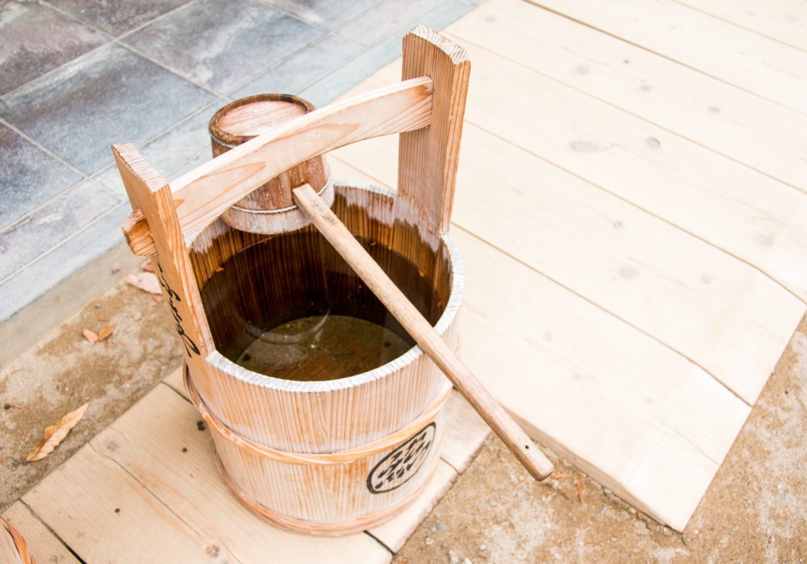 brown wooden bucket beside brown wooden chair
